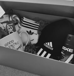 a box filled with adidas hats and other items