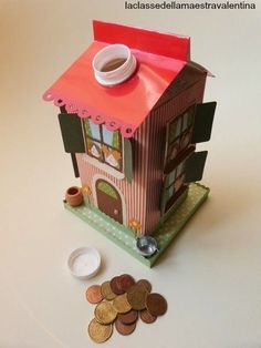 a paper doll house with coins on the floor