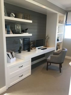 a white desk topped with a computer monitor next to a chair and bookshelf