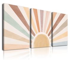 three canvases that have different colors and shapes on them, each with a sunburst