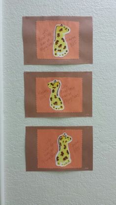 three pieces of paper with pictures of giraffes on them are hanging on the wall