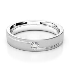 a white gold wedding band with a diamond in the center