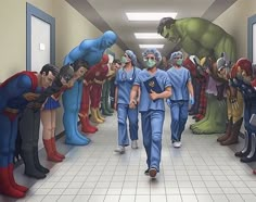 a group of people in scrub suits walking down a hallway with superheros painted on the walls