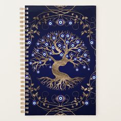 a spiral notebook with an image of a tree and blue eyes