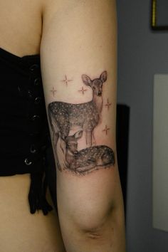 a woman with a deer tattoo on her arm