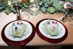 there are two plates with place cards on them