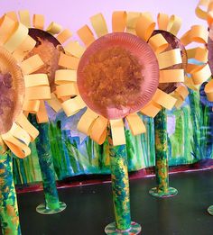 paper plate sunflowers are arranged in vases