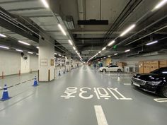 an empty parking garage with two cars parked in the space next to eachother