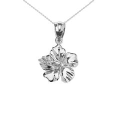 a white gold flower pendant on a chain