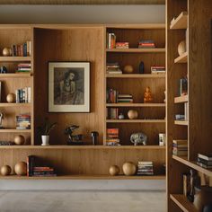 the bookshelves are full of books and vases