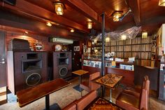 a room filled with lots of wooden furniture and bookshelves next to each other