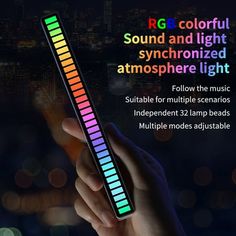 a person holding a colorful light up stick in their hand with the words rgb colored sound and light synchronizeded atmosphere light below