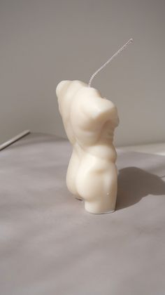 a white bear shaped candle sitting on top of a table