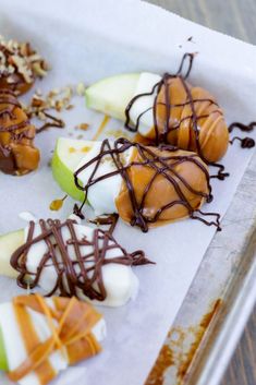 apples with chocolate drizzled on them and caramel slices in the middle