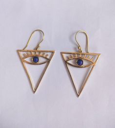 "Dainty Gold Blue Lapis Lazuli & Labradorite Evil Eye with Eyelash Huggie Earrings, Brass Charm, Eye Charm, Gifts for Her, Triangle Earrings Handmade Earrings Material:- Brass IMPORTANT NOTE....👇 1 product free gift on purchase of 3 products. You can choose the plain brass ring free gift as your wish. Take a screenshot of plain brass ring you like from my shop and send me a photo in personal message. MUST READ....👇 5 stars is my shop's priority. So contact me before leaving any negative review Triangle Metal Earrings For Gift, Symbolic Metal Dangle Earrings, Handmade Triangle Brass Jewelry, Triangle Shaped Single Earring As A Gift, Triangle Single Earring As Gift, Nickel Free Triangle Metal Earrings, Triangle Earrings As Gift, Triangle Pierced Earrings As Gift, Triangle Pierced Earrings Gift