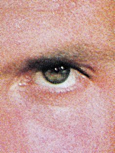 an image of the eye of a man with blue eyes and brown hair, looking straight ahead