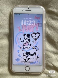 an iphone is sitting on a bed with its screen showing the cartoon dog and heart