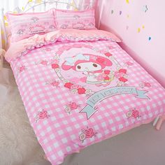 a pink and white bed in a girls room with polka dot bedspread, checkered comforter and pillows