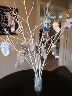 a vase filled with baby's socks on top of a table