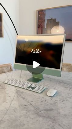 a desktop computer sitting on top of a marble table next to a keyboard and mouse