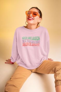 Get ready to groove with our "Get in, Loser, We're Doing Dance Stuff" sweatshirt! This playful and comfy sweatshirt combines humor and dance passion in one stylish package. Made from soft, cozy fabric, it's perfect for those chilly dance sessions or just lounging with friends. Featuring bold lettering and a fun design, this sweatshirt is sure to turn heads and spark smiles wherever you go. Whether you're hitting the dance floor or just vibing at home, this piece is your go-to for keeping it fun and fabulous. Embrace the dance life with a dash of attitude! Ideal for any situation, a unisex heavy blend crewneck sweatshirt is pure comfort. These garments are made from polyester and cotton. This combination helps designs come out looking fresh and beautiful. The collar is ribbed knit, so it re Dance Sweatshirt, Dance Teacher Gifts, Dancer Gift, Dance Lover, Dance Shirts, Dance Teacher, Comfy Sweatshirt, Funny Sweatshirts, Mom Outfits