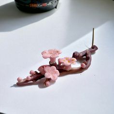 a close up of a flower decoration on a table with a camera in the background