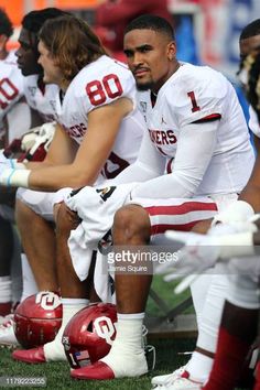 football players sitting on the sidelines during a game