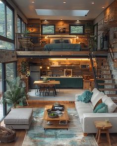 a living room filled with furniture and lots of windows next to a staircase leading up to a loft