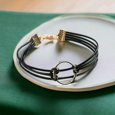 Faux Leather Cords With Standard Lobster Clasp Closure. Imported Chic Adjustable Leather Bracelet For Parties, Adjustable Round Trendy Choker, Trendy Adjustable Round Choker, Chic Adjustable Black Leather Bracelet, Chic Adjustable Black Choker, Modern Adjustable Black Choker, Adjustable Black Band Choker, Trendy Black Band Bracelet, Chic Black Metal Choker