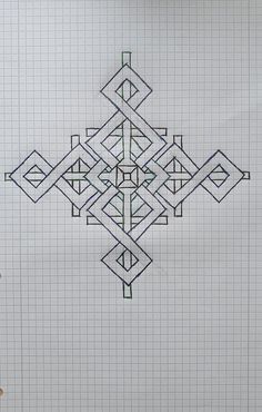 a drawing of an intricate design on a piece of paper with graph paper in the background