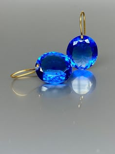 Gorgeous sparkly Swiss Blue Topaz earrings. The Faceted oval drops are flawless and eye clean and have a beautiful vivid clear deep blue color. The earrings are elegant and bold, and make a statement. A truly gorgeous pair of earrings. When 14K SOLID GOLD ear wires are being used, the ear wire ends are hand-stamped as proof of being 14K solid gold. In addition, extra work was done at the end of the ear wires to prevent any sort of pain or injury while inserting them through the ear lobes. **The Blue Briolette Earrings For Formal Occasions, Luxury Blue Briolette Earrings, Blue Tanzanite Round Earrings, Blue Topaz Oval Earrings, Blue Oval Topaz Earrings, Blue Gemstone Accented Round Earrings, Blue Faceted Drop Earrings, Modern Oval Blue Earrings, Modern Blue Oval Earrings