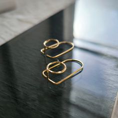 "Pair of long architectural earrings in 3D, designed in 14k gold-filled*, with a completely unique and original style. Johe Jewelry reinvents the earring with its collection of contemporary and minimalist architectural hoops: a surprising style that adorns the ear perfectly, enveloping it on both sides. This collection of jewelry is both simple and original, as well as timeless: no matter your style, there is undoubtedly a perfect match for you. The architectural earrings will enhance your outfi Architectural Earrings, Gold Wire, Gold Hoops, Golden Color, In 3d, Real Gold, Designer Earrings, Perfect Match, Jewelry Earrings Dangle