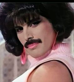 a close up of a person with a moustache on their face and black hair