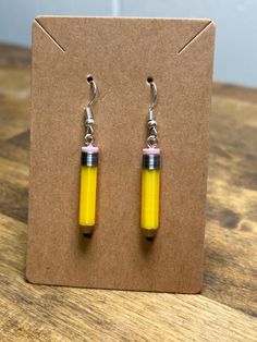 Add a touch of fun and creativity to your classroom with these adorable pencil earrings, perfect for teachers who love to inspire! Crafted with attention to detail, these lightweight earrings are designed to resemble classic yellow pencils, making them a delightful accessory for any educator. Whether you're celebrating back-to-school season, looking for the perfect teacher appreciation gift, or simply want to showcase your passion for teaching, these pencil earrings are sure to bring a smile to Earrings For Teachers, Washer Crafts, Pencil Earrings, Pop Tab Crafts, Classroom Accessories, Teacher Gift Back To School, Cute Pencil, Quirky Earrings, Best Teacher Gifts