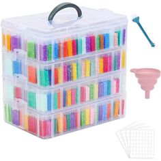 a plastic box filled with lots of different colored beads next to a toothbrush and holder