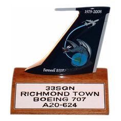 a wooden trophy with a black and white boat on it's base that reads, 350n richmond town boeing 707 a0 - 644