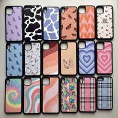 many cell phones are lined up together on a table with hearts and zebras painted on them