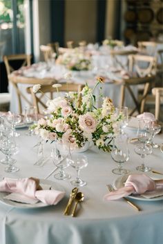 the table is set with pink napkins and silverware for an elegant wedding reception