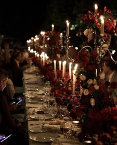 a long table is set with candles and plates