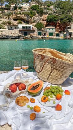 a picnic with fruit and wine on the beach