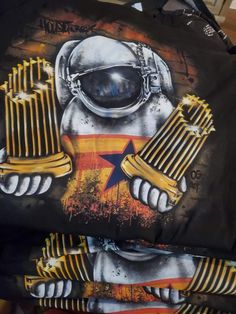 the back of a jacket with an image of a spaceman holding two combs