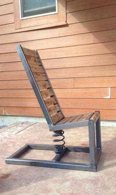 a metal chair sitting on top of a wooden floor next to a building with a window