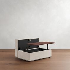 an open box sitting on top of a wooden floor next to a white table and chair