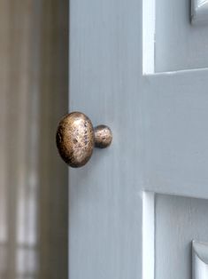 a close up of a door handle on a white door