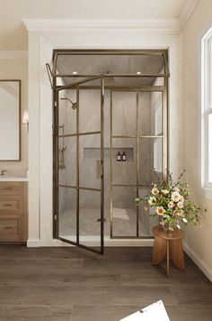 a bathroom with a walk in shower next to a sink and mirror on the wall