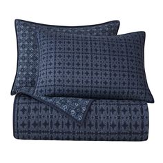 two blue pillows with black and white designs on the pillowcase, one is folded in half