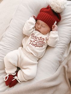 Santa's cutest little helper just got cuter with this soft bubble romper! This buttery soft, cream-colored, one-piece is made from 100% organic cotton for the ultimate comfort. With holly red embroidery that says "Santa's Little Helper," your baby will look absolutely festive this holiday season. Now bring on the gifts! Santa's Little Helper Romper matches our Luna + Luca Pom Beanie in Holly and the Luna + Luca Organic Booties in Holly 100% Organic Cotton Features: Snap closure at inseam Snap cl Baby With Santa Pictures, Baby Christmas Onesie, Newborn Summer, Girls Wedding Shoes, First Communion Shoes, Christmas Baby Pictures, Baby Boy Christmas Outfit, Stylish Baby Clothes, Diaper Bag Accessories