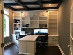 a home office with built in shelving and desk