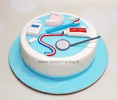 a cake with toothbrushes, dental floss and other items on it sitting on a blue plate