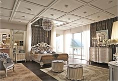 a large bedroom with white furniture and chandelier